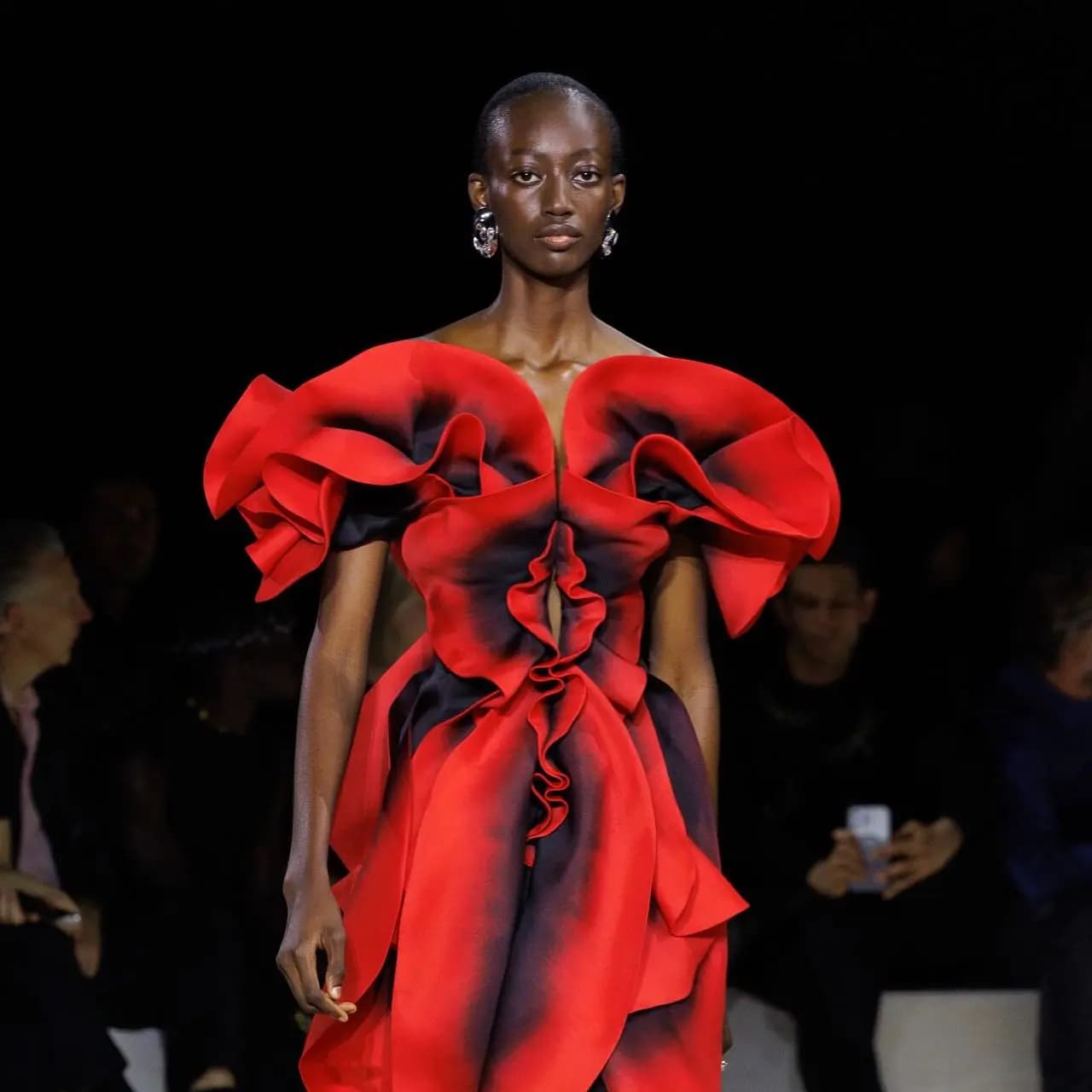 a model catwalking with an Alexander McQueen dress.