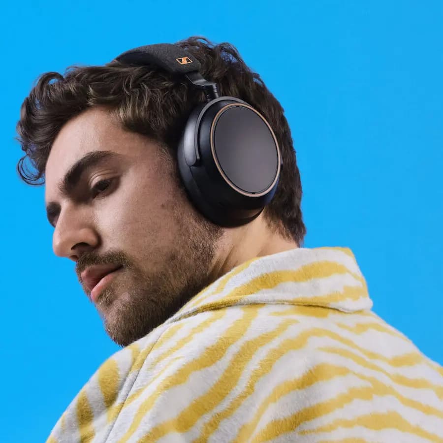 a man posing with a Sennheiser hearing headset.